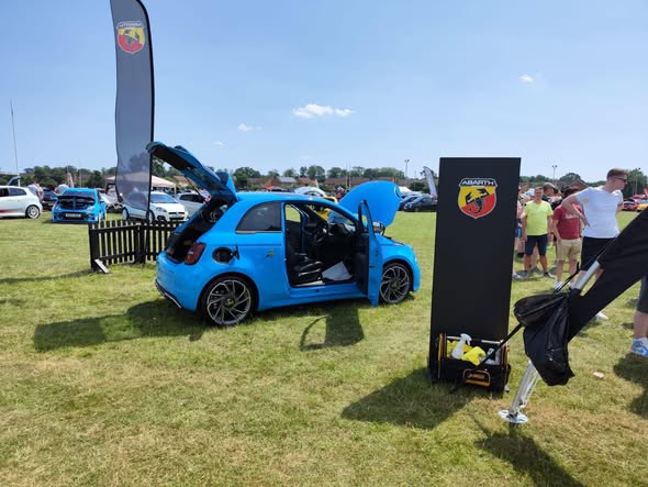 Blue Abarth 500e on display stand at Owners Club Day — prepared by Carswells