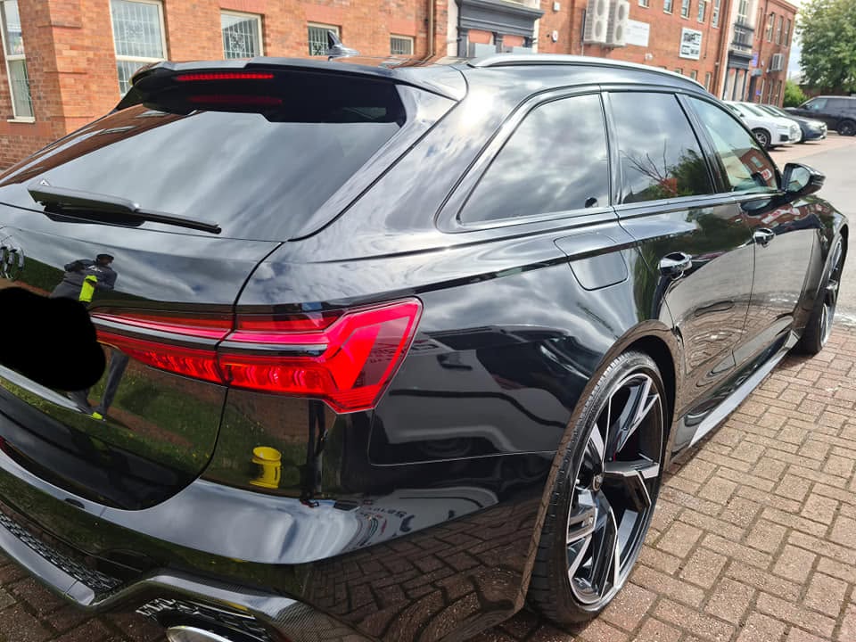 Audi RS6 rear three-quarter view — mirror-like gloss from machine polishing