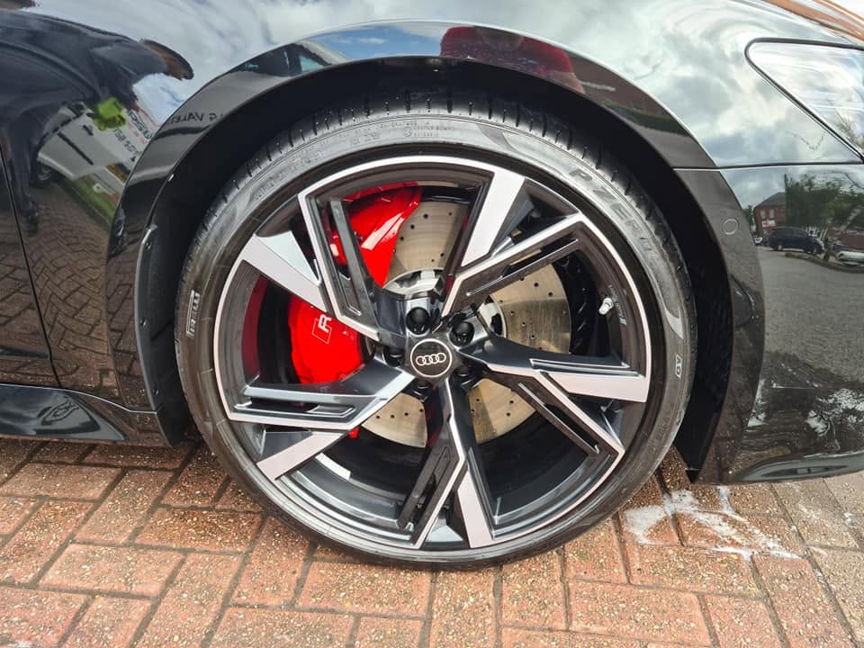 Audi RS6 forged wheel and red RS brake caliper — dressed and detailed