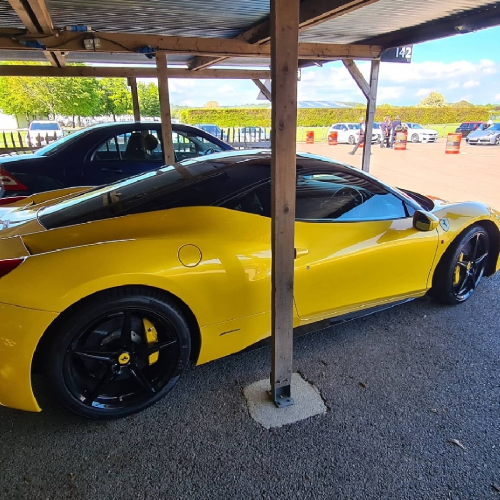 Yellow Ferrari 458 in the event paddock