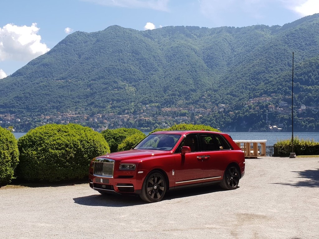 Red Rolls-Royce Cullinan on the shores of Lake Como