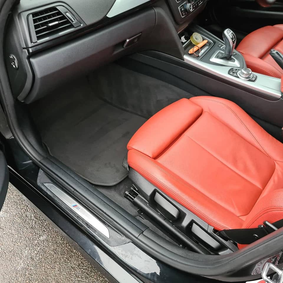 BMW M Sport red leather interior after — deep cleaned carpet, conditioned leather, M sill gleaming