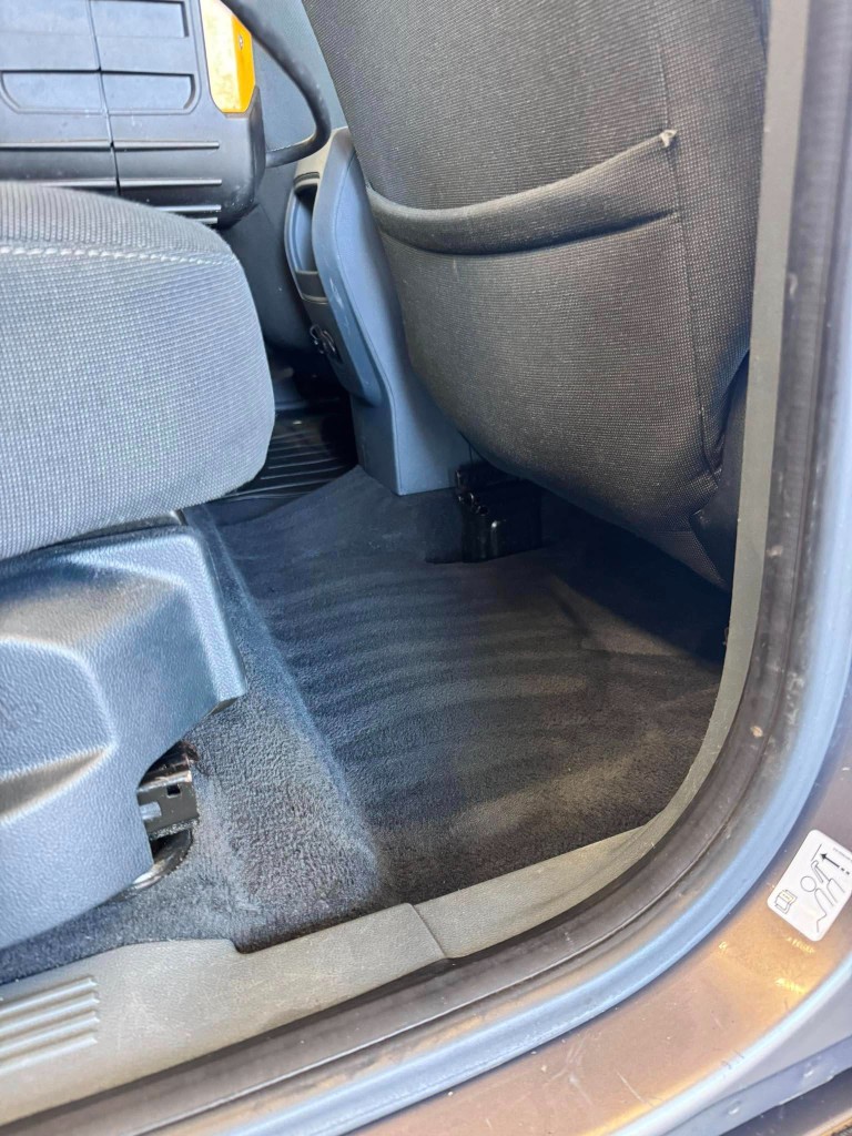 MPV rear footwell after — deep vacuumed and shampooed carpet, spotless finish