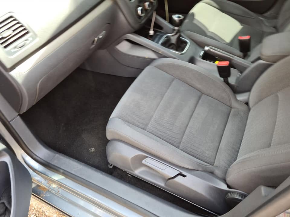 VW front interior after full deep clean — vacuumed carpet, clean sill, fresh seats