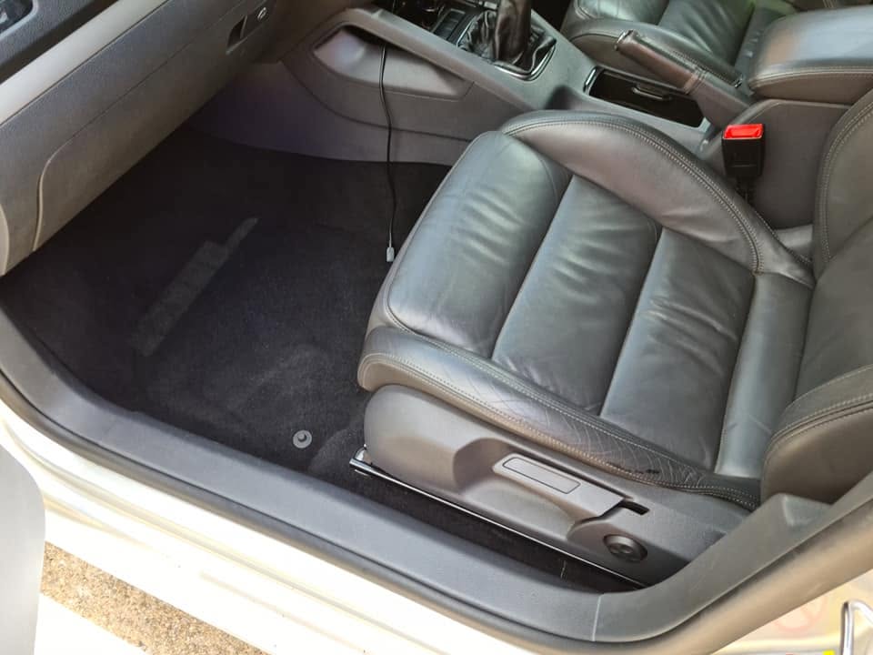 VW leather interior after — deep cleaned carpet, conditioned leather, clean dashboard